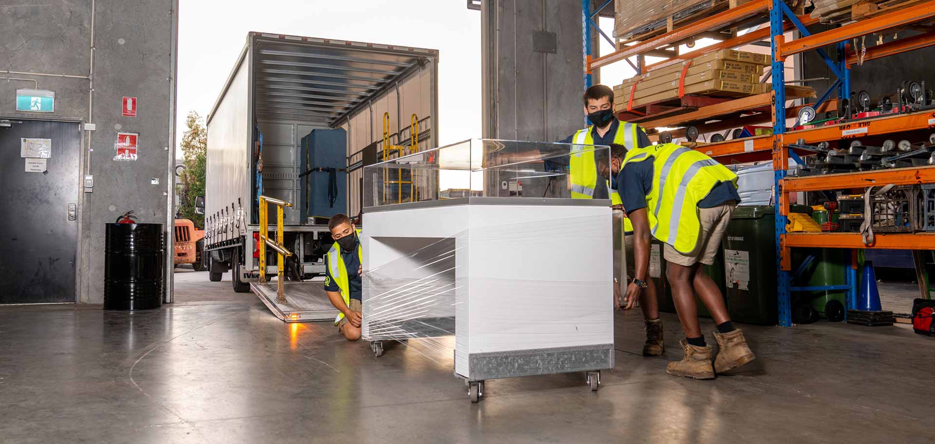 People wrapping freight with protective material