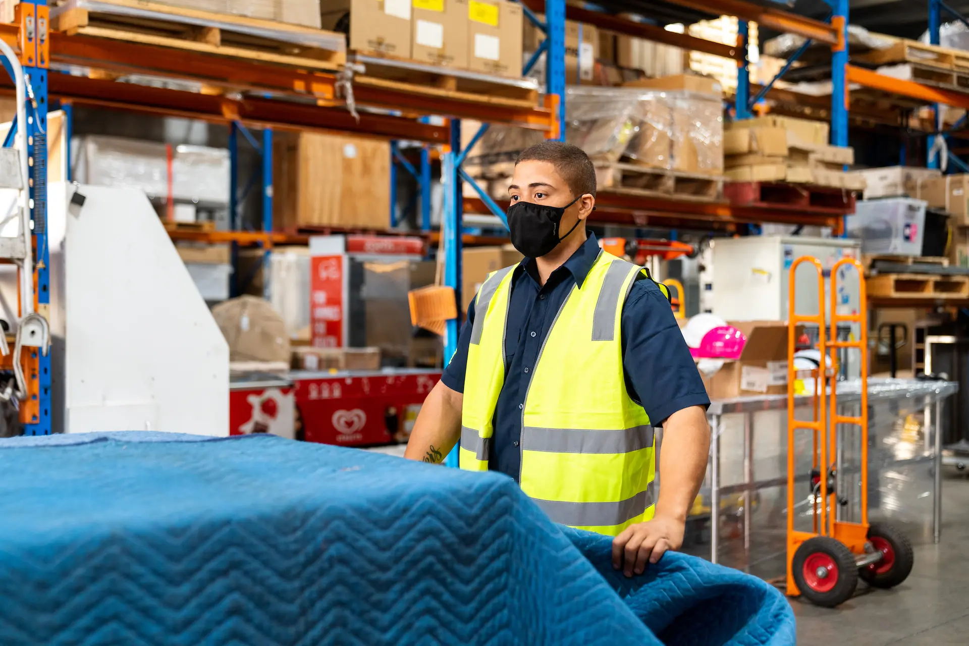 Person loading freight while wearing a mask