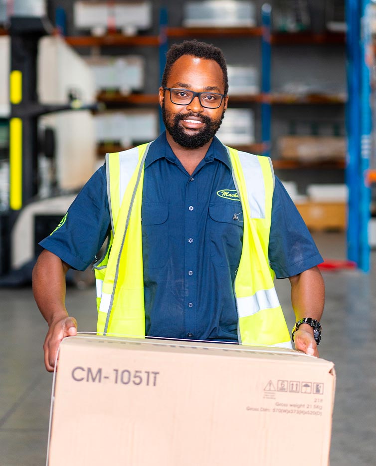 Man smiling at the camera while holding a box