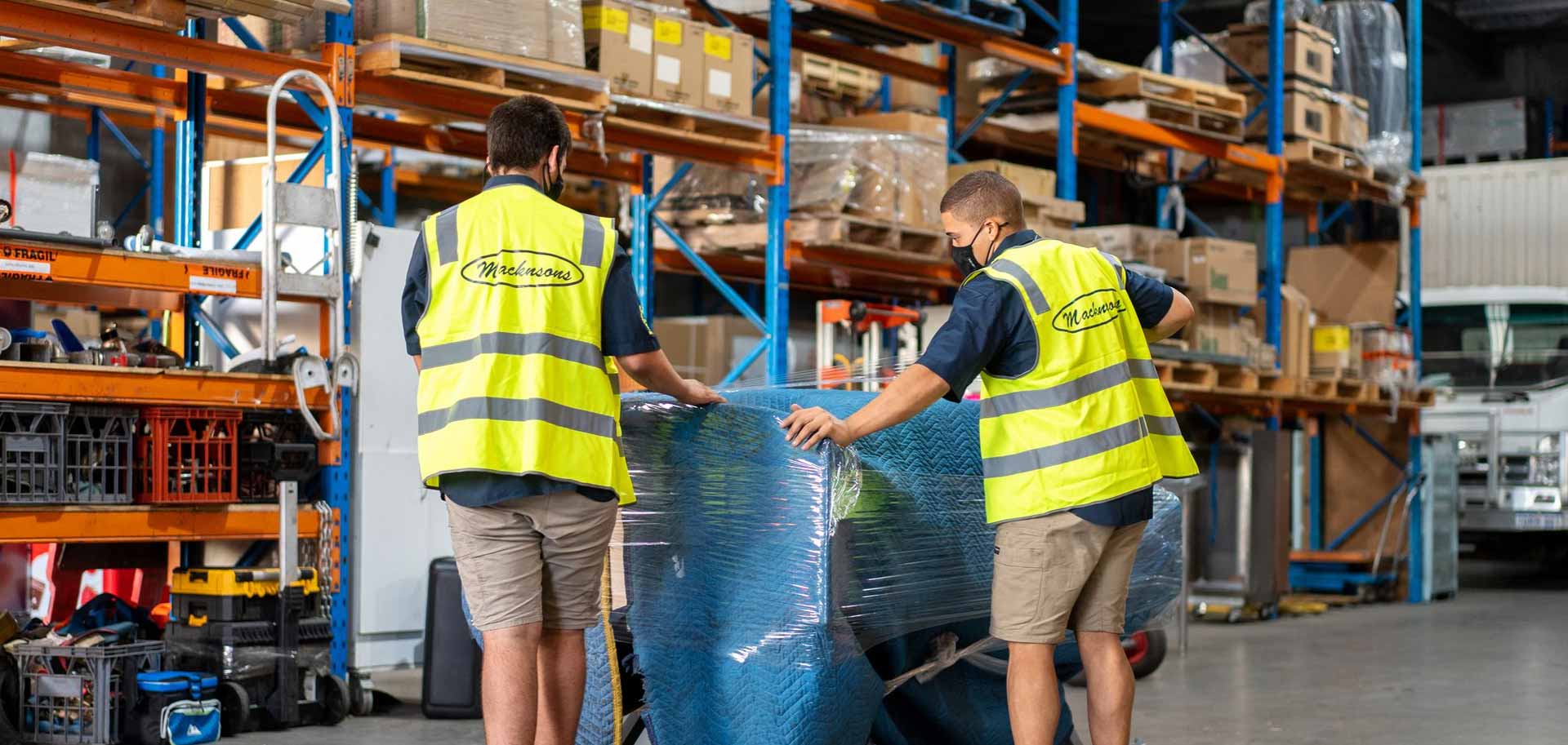 People wrapping freight in protective materials